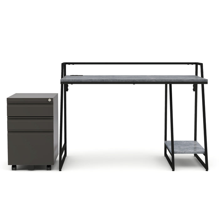 Front-facing urban grey computer desk and file pedestal set against a white background. The black-framed desk features a lower open shelf. The gunmetal 3-drawer file pedestal sits on wheels and features a key-lock on the upper right corner. 