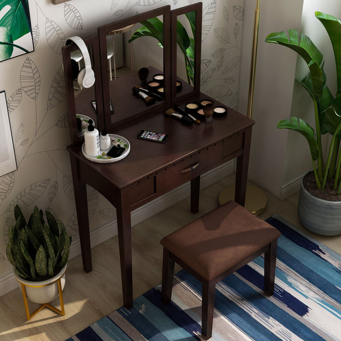 Top view of an espresso vanity set in a contemporary bedroom. Make-up, lotions, and an iPhone sit on the tabletop while greenery surrounding the set creates a down-to-earth atmosphere.