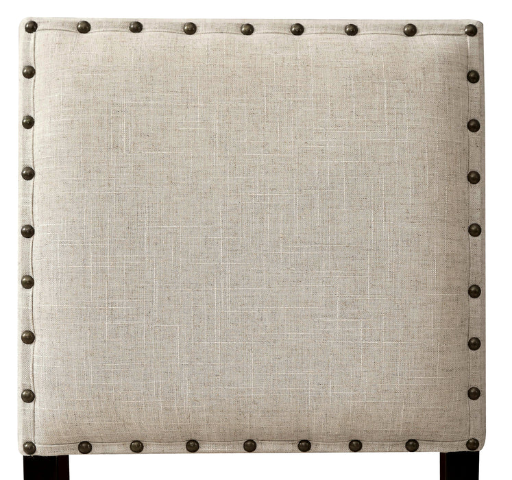 Front-facing detail shot of the beige faabric square chair back with nailhead trim.
