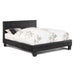 Right-angled black faux crocodile leather platform bed against a white background.