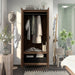 Front-facing tall, distressed walnut wardrobe cabinet with two open doors in a casual bedroom with accessories