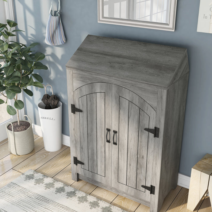 Left-facing top-down transitional vintage gray oak shoe cabinet with adjustable shelves and flip top shelf in a modern farmhouse mudroom with accessories. Rustic black door pulls and black hinges.