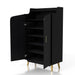 Left-facing modern black shoe cabinet opened to reveal five shelves and curved doors on white background. Slim gold finish pulls and flared legs.