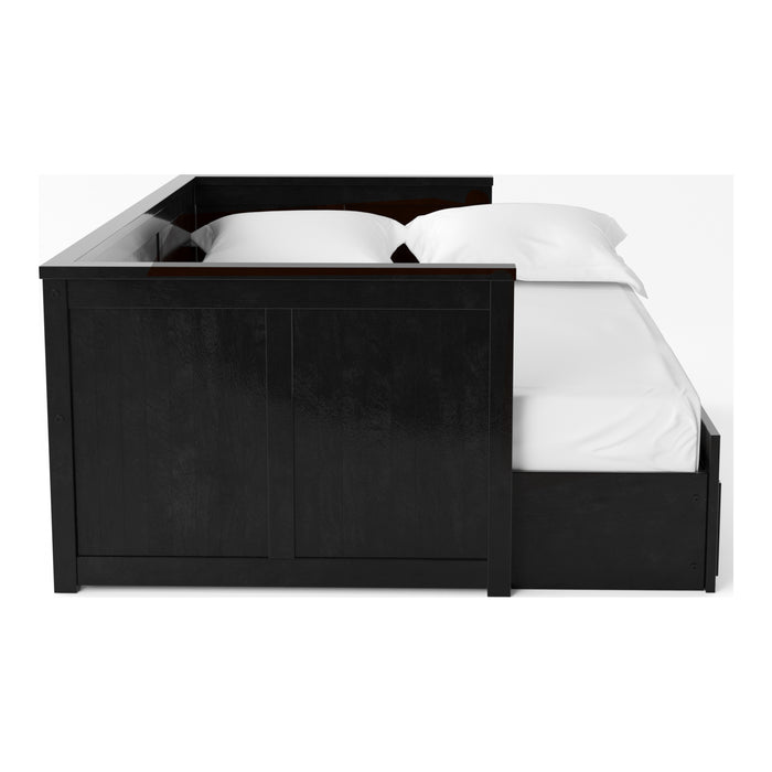 Front-facing side view cottage style black daybed with three drawers and white linens on a white background