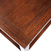 Top-down close-up detail of cherry finish wood tabletop of transitional rectangular end table on a white background