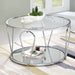 Right angled modern round chrome steel coffee table with open teardrop shape legs, a decorated tempered glass top and mirror open bottom shelf on a rug in a living room.