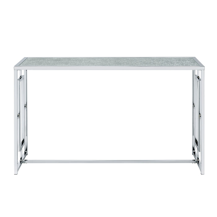 Front-facing view of modern chrome plated steel sofa table with geometric trestle base and waterfall pattern tempered glass top on a white background