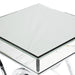 Close-up view of partial table surface of contemporary glam chrome finish steel and mirror end table.