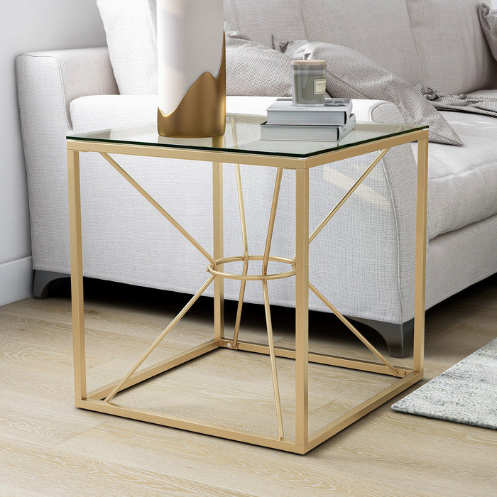 Left angled glam gold and glass square end table in a living room with accessories