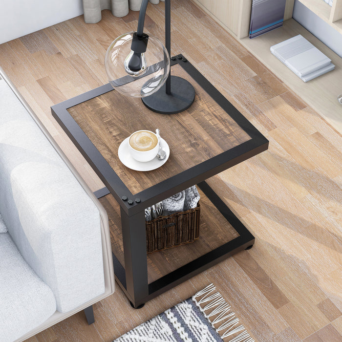 Top-down urban walnut end table with asymmetrical sand black frame and table lamp next to a sofa.