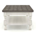 Front facing side view of a transitional one-shelf antique white and gray wood coffee table on a white background