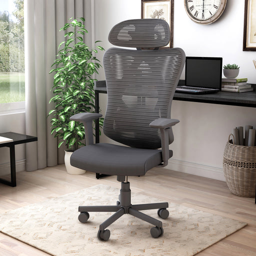 Left angled contemporary black office chair with mesh and a headrest in a home office with accessories
