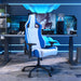 Right angled modern blue and white faux leather gaming chair at a desk with accessories
