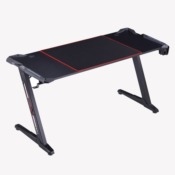 Right angled contemporary black gaming desk with red accents on a white background