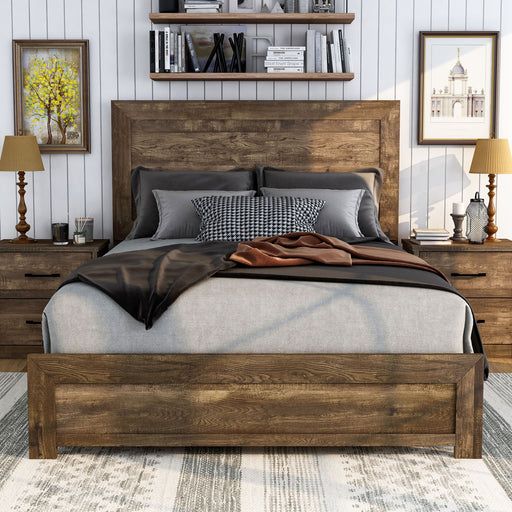 Front-facing rustic walnut panel bed in a farmhouse-style bedroom. Neutral bedding with black and cognac accents the wood tone. Two frames on either side and wood shelves above the bed hang on the white shiplap wall.