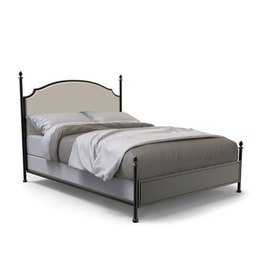 Right-angled California King-sized four-poster bed sits against a white background. The camelback is a beige upholstery while the frame of the bed is a gunmetal finish with slender posts that present ball finials.