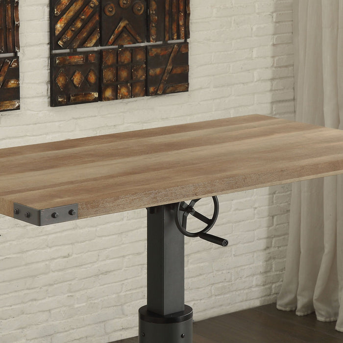 Angled and cropped right-facing view of industrial black and rustic oak steel and veneer adjustable desk in living space with chair and accessories