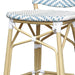 Detail shot of a blue and white chevron patterned wicker patio bar chair with a natural tone frame.