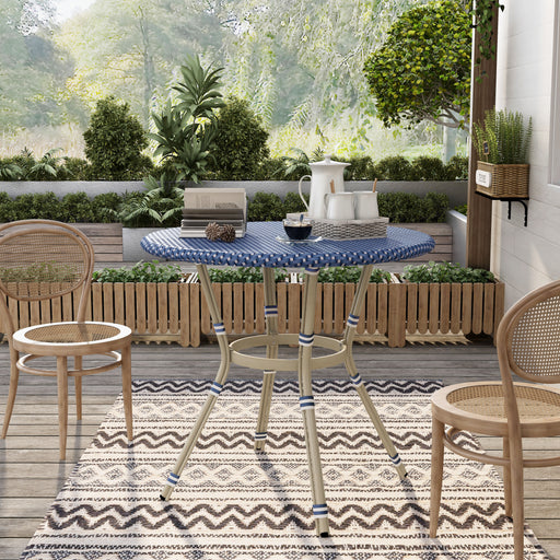 Front-facing French style blue and white wicker counter height patio dining table on a patio with accessories