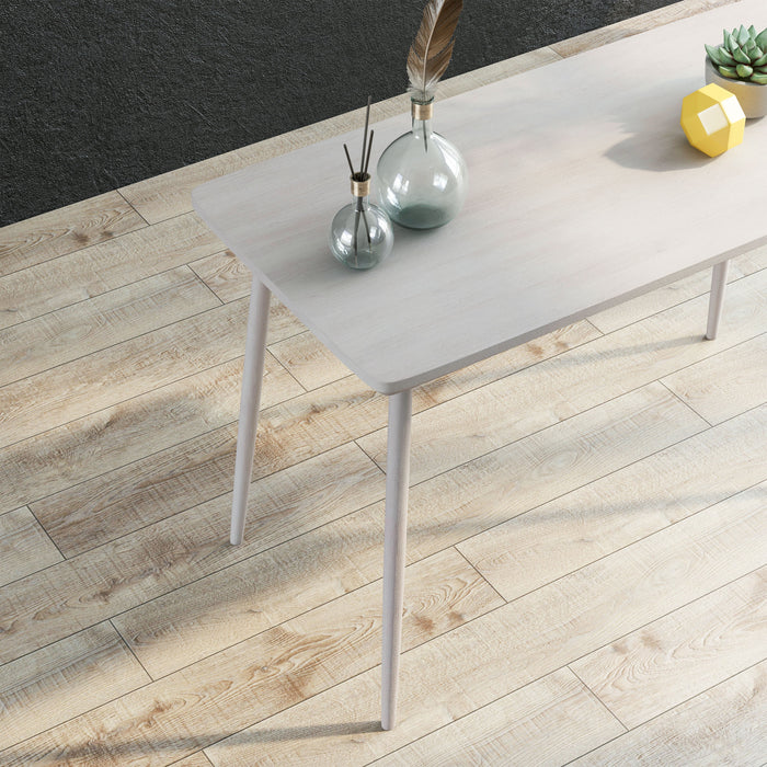 Cropped, Angled, top-down view of contemporary white oak finish writing desk in living space with accessories