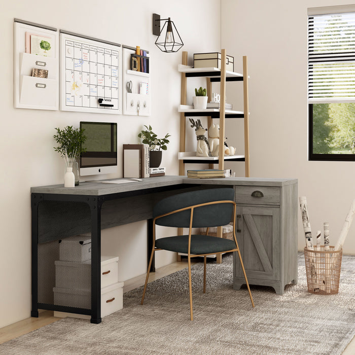 Right angled farmhouse vintage gray oak L-shaped desk in a home office with accessories