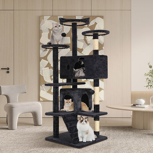 Left facing modern dark grey multi-level cat playhouse tower with cats in a room with accessories