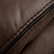 Right facing close up of the stitching of a transitional brown microfiber reclining loveseat with console and accent stitching on a white background