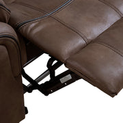 Right facing close up of the raised leg rest of a transitional brown microfiber reclining loveseat with console and accent stitching on a white background