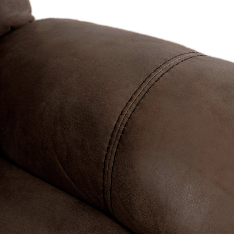 Right facing close up of the armrest of a transitional brown microfiber reclining sofa with accent stitching on a white background