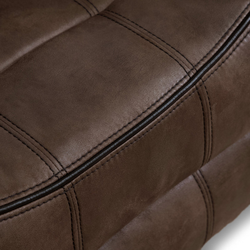 Right facing close up of the seat of a transitional brown microfiber reclining sofa with accent stitching on a white background