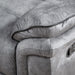 Left facing close up of the armrest of a transitional grey microfiber recliner with accent piping