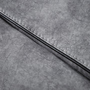 Close up of the upholstery fabric of a transitional grey microfiber sofa with accent piping