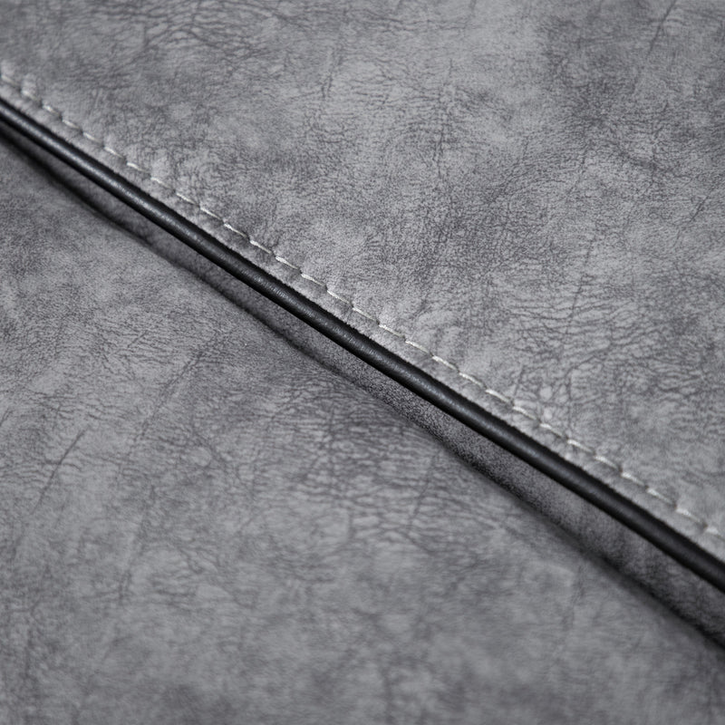 Close up of the upholstery fabric of a transitional grey microfiber sofa with accent piping