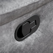 Left facing close up of the recline lever of a transitional grey microfiber sofa with accent piping