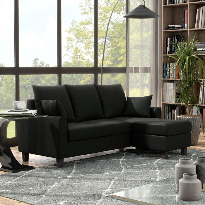 Right facing transitional black customizable sectional sofa in a room with accessories