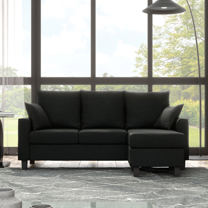 Front facing transitional black customizable sectional sofa in a room with accessories