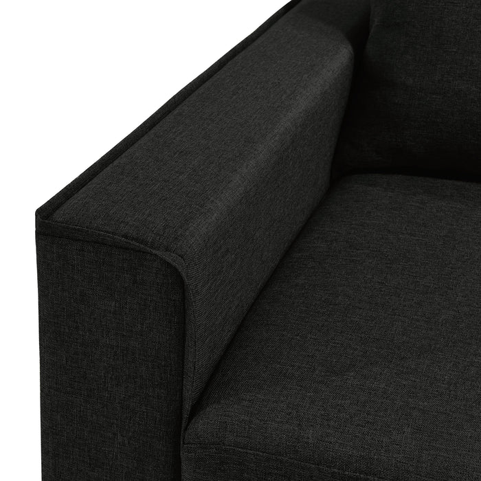 Left facing close up of the armrest of a transitional black customizable sectional sofa on a white background