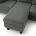 Left facing close up of the ottoman of a transitional dark grey customizable sectional sofa on a white background