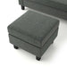 Left facing close up of the detached ottoman of a transitional dark grey customizable sectional sofa on a white background
