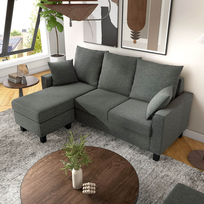 Left facing bird's eye view of a transitional dark grey customizable sectional sofa in a room with accessories
