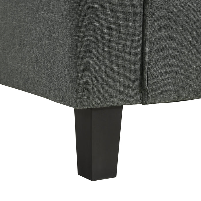 Left facing close up of the leg of a transitional dark grey customizable sectional sofa on a white background