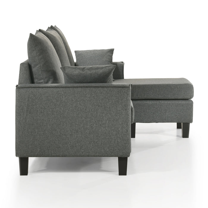 Front facing side view of a contemporary grey sectional sofa with an adjustable ottoman on a white background