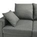Close up view of the seat and armrest of a contemporary grey sectional sofa with an adjustable ottoman on a white background