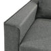 Close up view of the armrest of a contemporary grey sectional sofa with an adjustable ottoman on a white background