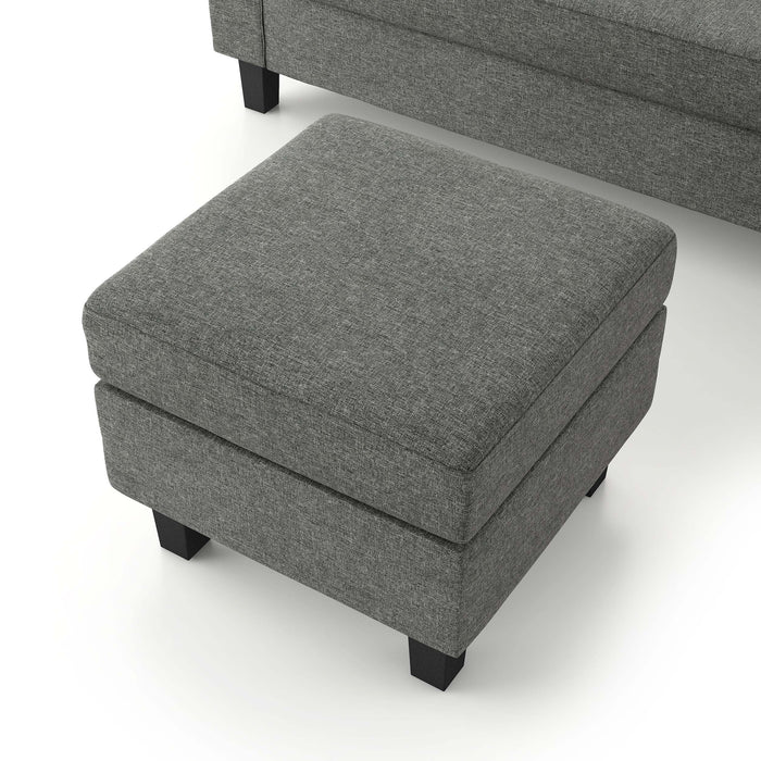 Close up view of the detached ottoman of a contemporary grey sectional sofa with an adjustable ottoman on a white background