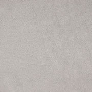 Swatch of the upholstery fabric of a modern grey velvet loveseat with sloping arms
