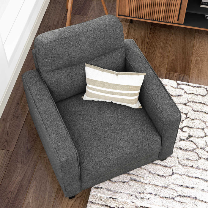 Right facing bird's eye view of a transitional grey linen-look accent armchair in a room with accessories