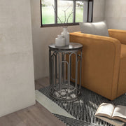 Right facing contemporary black natural stone and metal round small accent end table in a room with accessories