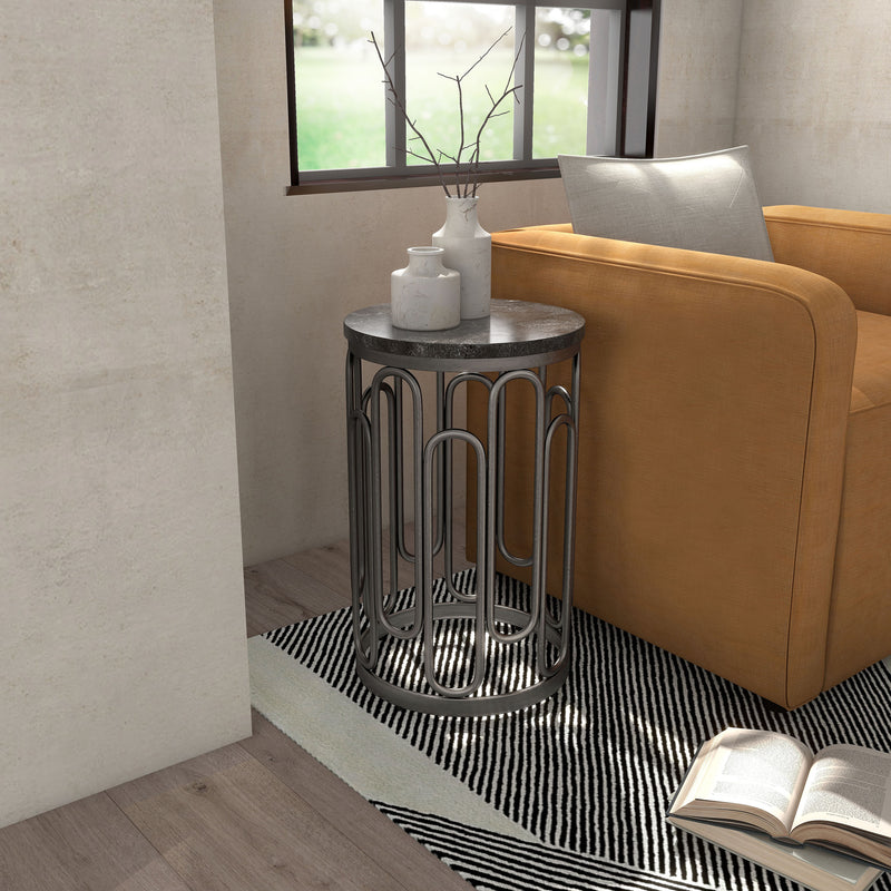 Right facing contemporary black natural stone and metal round small accent end table in a room with accessories