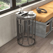 Right facing contemporary black natural stone and metal round small accent end table in a room with accessories